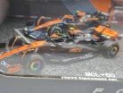 Set McLaren F1 - #4 Lando Norris - GP-ul Marii Britanii 2023 - GP-ul Singapore 2023 - GP-ul Monaco 2023 - Abu Dhabi 2022 - Bburago - 1:43